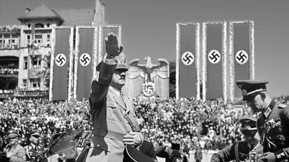 Hitler saluting troops of the Condor Legion, German volunteers who fought alongside General Franco's Nationalists in the Spanish civil war